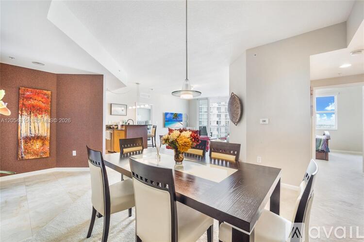 A dining room with a table set for four.