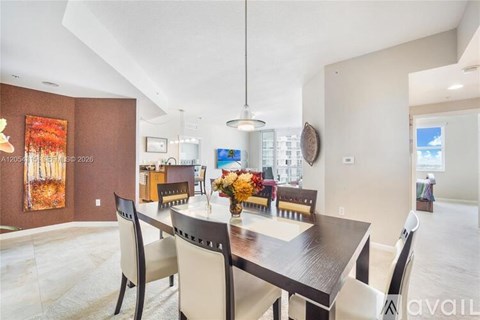 A dining room with a table set for four.