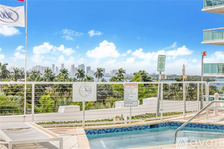 A pool area with a view of the city skyline.