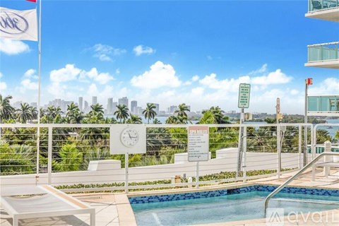 A pool area with a view of the city skyline.