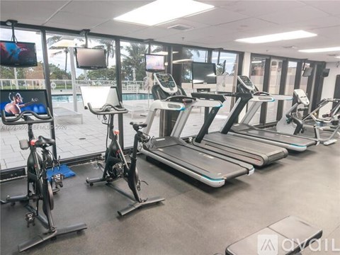 A gym with treadmills and exercise bikes.