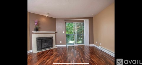 A living room with a fireplace and sliding glass doors.