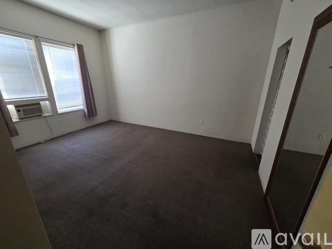 Empty room with a window and a microwave.
