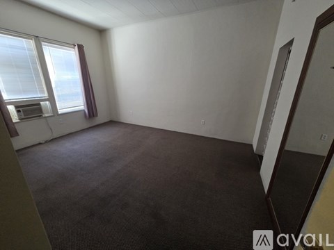 Empty room with a window and a microwave.