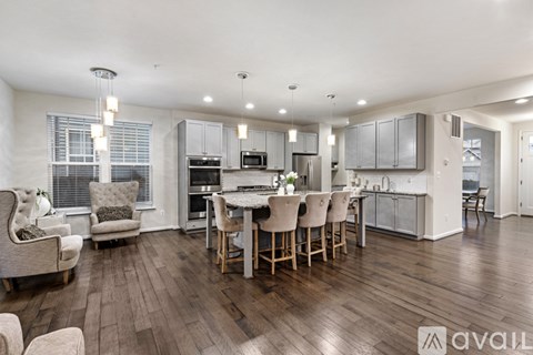 A modern kitchen with a dining table and chairs.