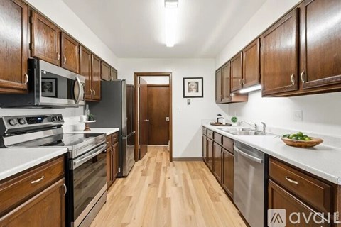 A kitchen with wooden cabinets and stainless steel appliances.