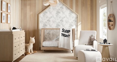 A cozy bedroom with a bed that has a "Sleep Tight" blanket on it.