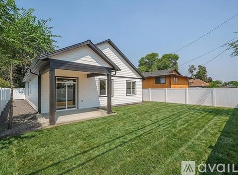 A house with a white exterior and a covered patio area.