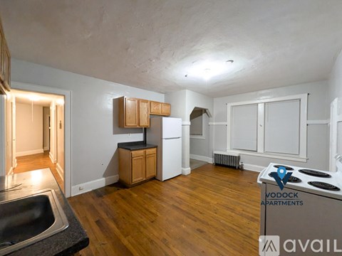 A kitchen with a stove top oven and a sink.