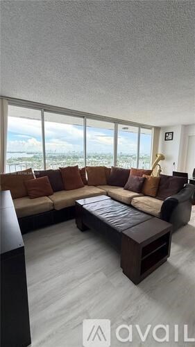 A living room with a large couch and a coffee table.