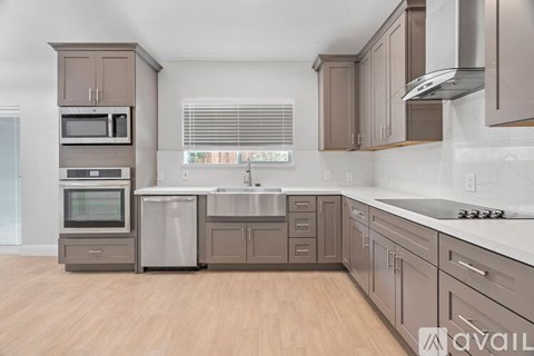 A kitchen with brown cabinets and a white counter top.