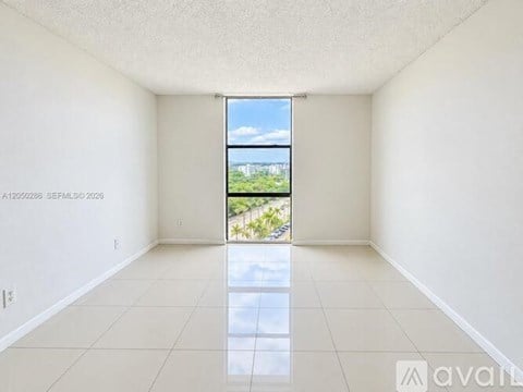 Empty room with a view of the outdoors through a window.