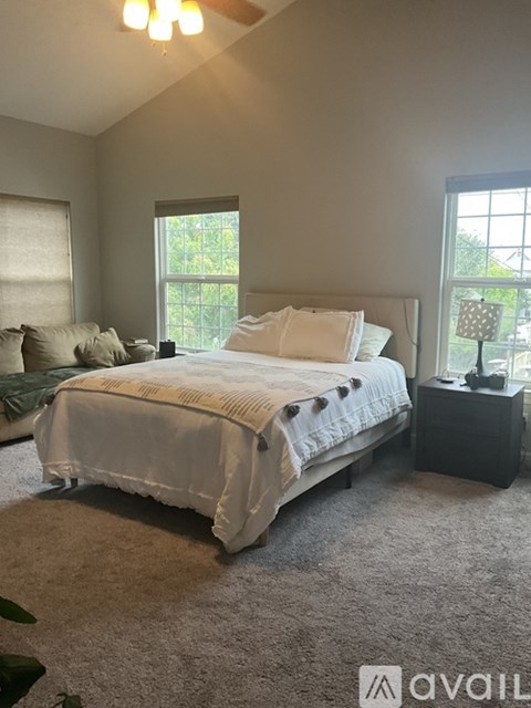 A bedroom with a large bed and a window.
