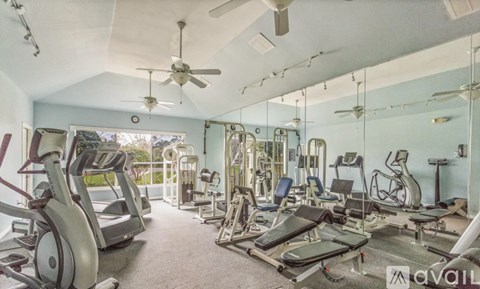 A well-equipped gym with a variety of exercise machines.