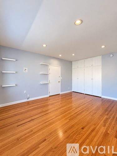 A room with wooden floors and white walls.