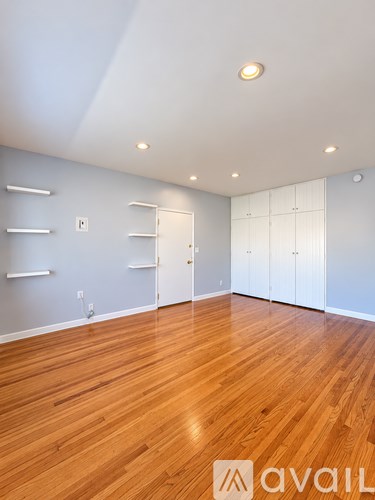 A room with wooden floors and white walls.