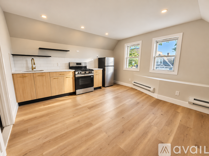 A kitchen with wooden floors and a refrigerator.