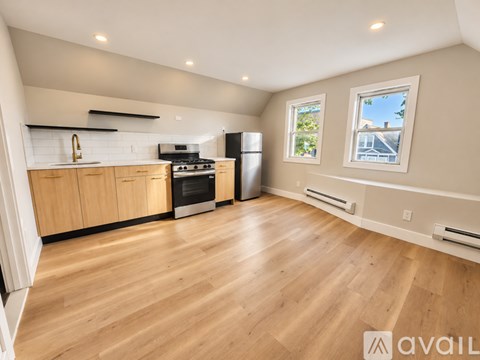 A kitchen with wooden floors and a refrigerator.
