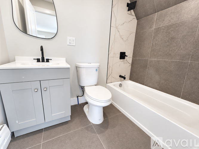 A bathroom with a white toilet, sink, and bathtub.