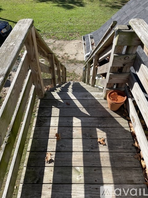 A wooden staircase leading down to a grassy area.