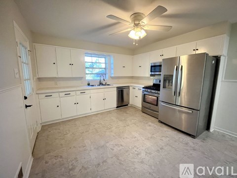 A kitchen with white cabinets and stainless steel appliances.