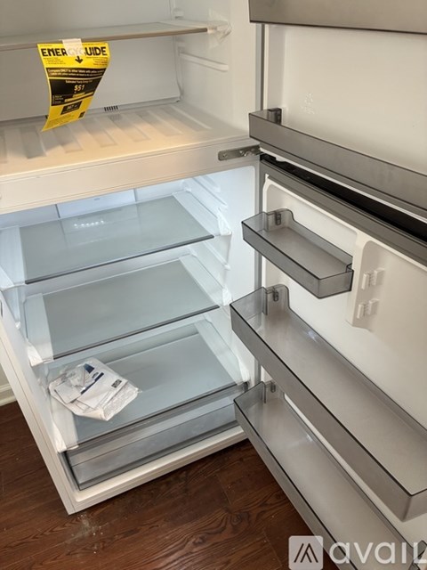 A white refrigerator with a yellow caution sign on the door.