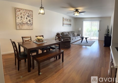 A dining room with a wooden table and chairs.