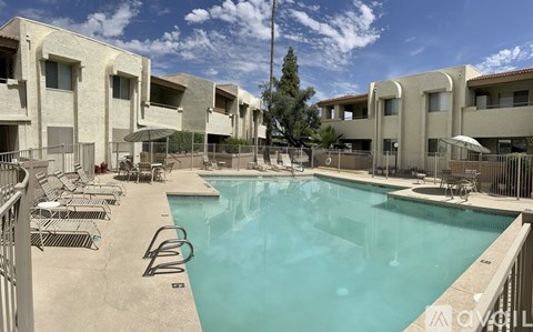 A swimming pool surrounded by a concrete building.