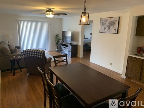 A living room with a brown table and chairs.
