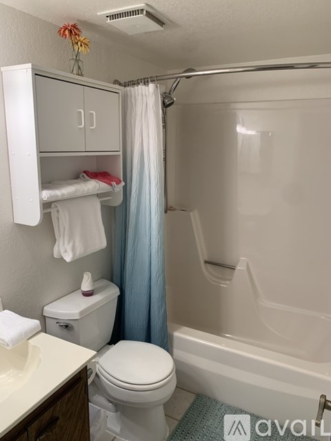 A small bathroom with a toilet, sink, and bathtub.