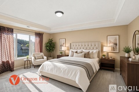 A well-lit bedroom with a large bed and a window with curtains.