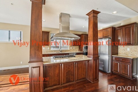 A kitchen with wooden cabinets and a center island with a stove and oven.
