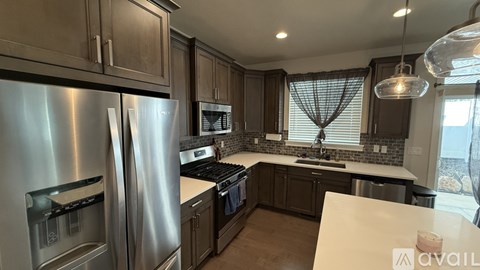A modern kitchen with stainless steel appliances and a central island.