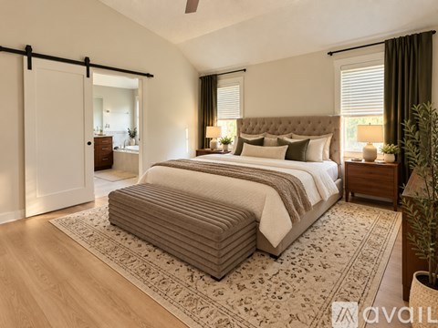 A bedroom with a large bed and a ceiling fan.