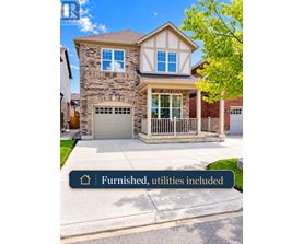 A house with a stone facade and a garage.