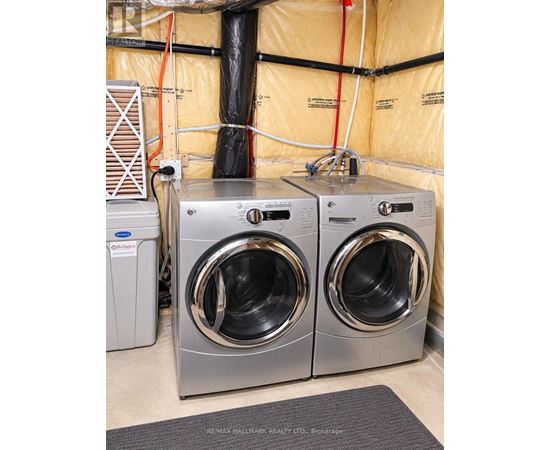 Two front loading washing machines in a laundry room.
