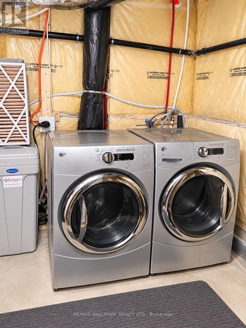 Two front loading washing machines in a laundry room.