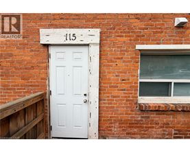 A white door with the number 115 above it.