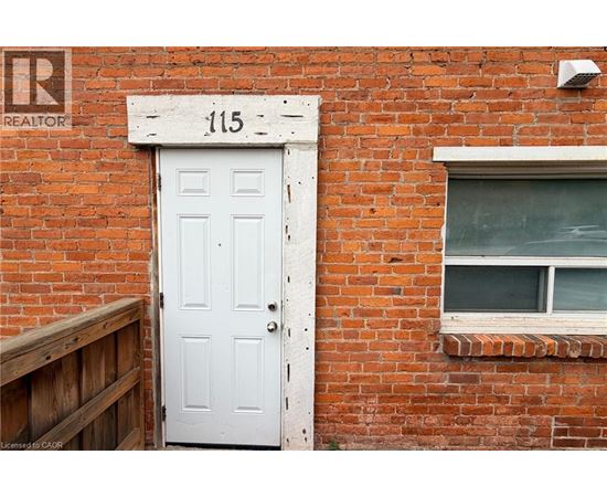 A white door with the number 115 above it.