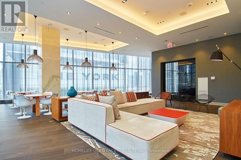 A living room with a white couch and a wooden coffee table.