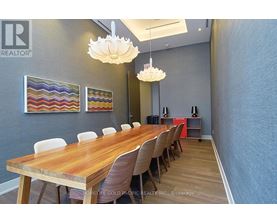 A conference room with a long table and chairs.