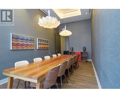 A conference room with a long table and chairs.