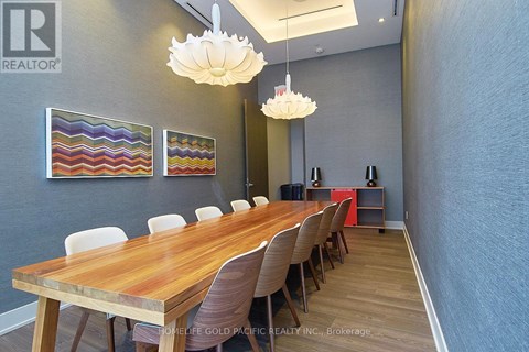 A conference room with a long table and chairs.