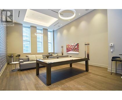 A room with a pool table and a couch.