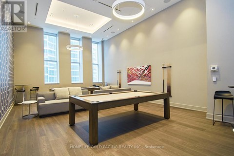 A room with a pool table and a couch.