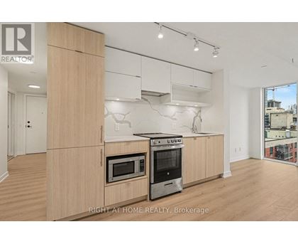 A modern kitchen with wooden cabinets and stainless steel appliances.