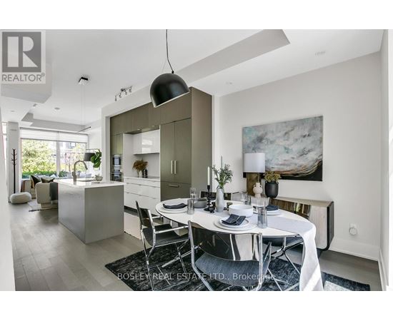 A modern dining room with a white table set for two.