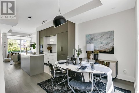 A modern dining room with a white table set for two.