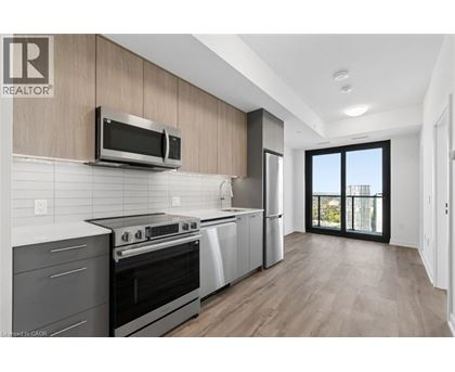 A modern kitchen with a stainless steel oven and microwave.