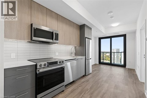 A modern kitchen with a stainless steel oven and microwave.